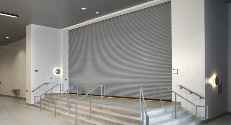 Heavy-duty steel sectional garage door installed at an industrial facility